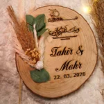 Rustic wood slice Nikkah ring tray with laser-engraved names and dried flowers