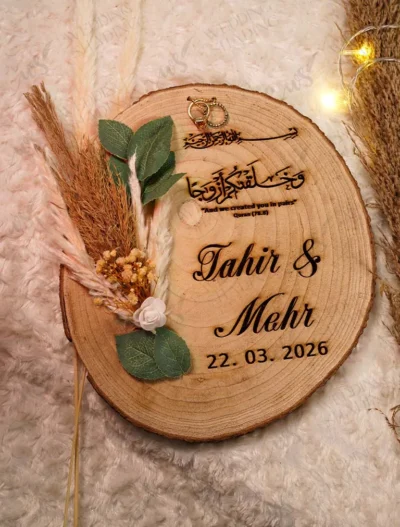 Rustic wood slice Nikkah ring tray with laser-engraved names and dried flowers