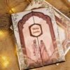 Gold cord handle on the folded traditional wedding card