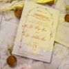 Close-up of calligraphy-style couple names on white wedding card
