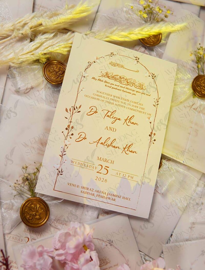 Close-up of calligraphy-style couple names on white wedding card
