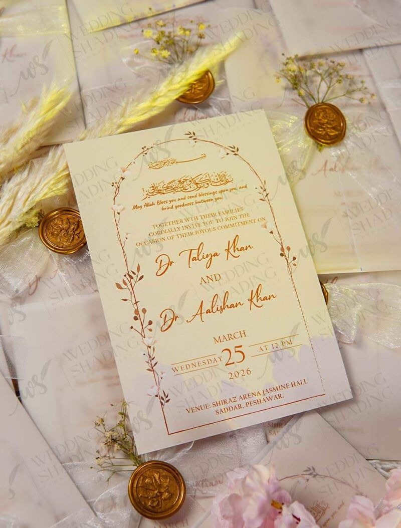 Overhead arrangement of multiple finished white wedding invitations